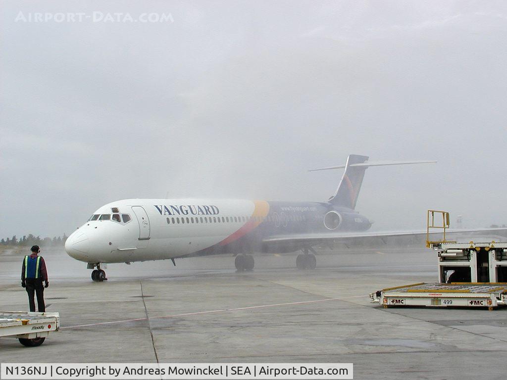N136NJ, 1990 McDonnell Douglas DC-9-87 C/N 49413, Vanguard Airlines operated at SEA between June 3 and July 30, 2002. Photographer was the Station Manager. In picture an MD87 taxiing through the waterarch after the inaugural flight
