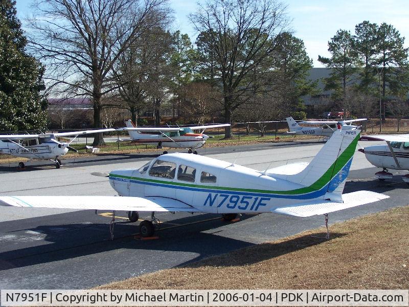 N7951F, 1976 Piper PA-28-151 C/N 28-7715249, Tied down @ PDK with vairous AC in background