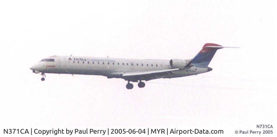 N371CA, 2003 Bombardier CRJ-701ER (CL-600-2C10) Regional Jet C/N 10082, You can barely see the wingtip vortices due to the humidity