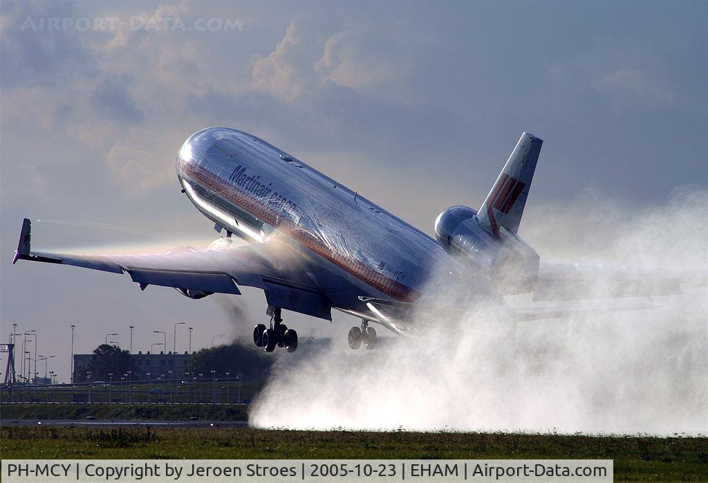 PH-MCY, 1991 McDonnell Douglas MD-11F C/N 48445, Rain, sun and wet runway creats nice moments