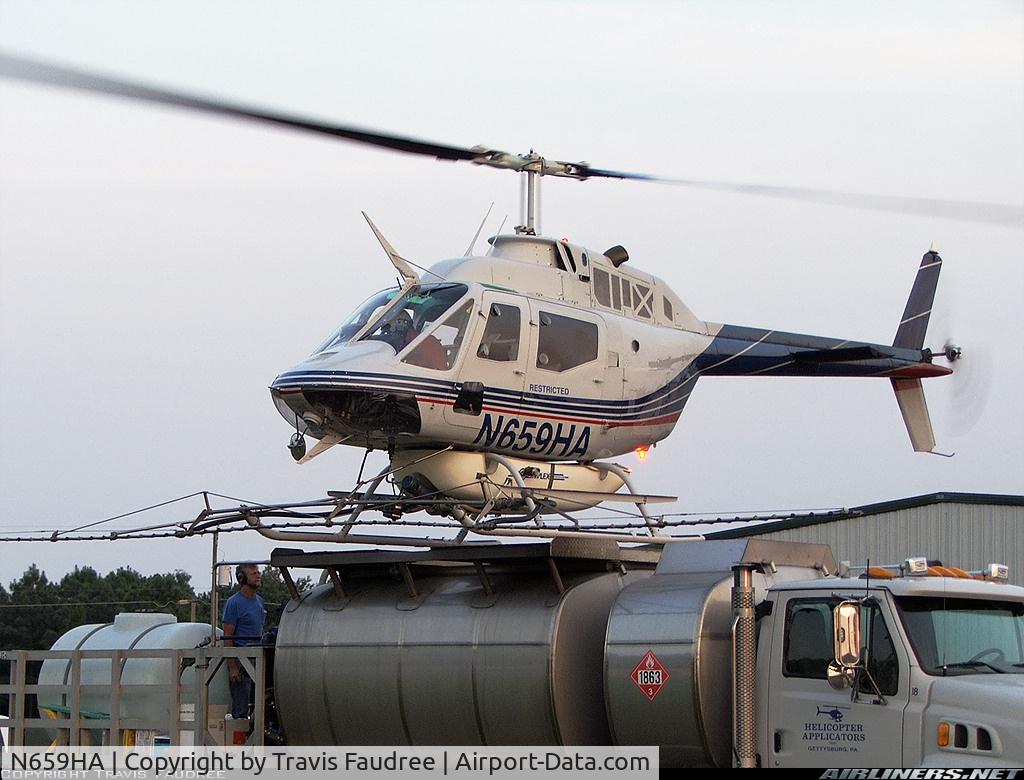N659HA, 1971 Bell OH-58C Kiowa C/N 40710 (70-15159), N659HA (cn 70-15159) This Bell chopper is one of 13 used by a Gettysburg, PA company as aerial applicators. The pilot is seen here concentrating on hitting his mark, which happens to be a helipad attached to the top of a tanker truck. The truck is equippe