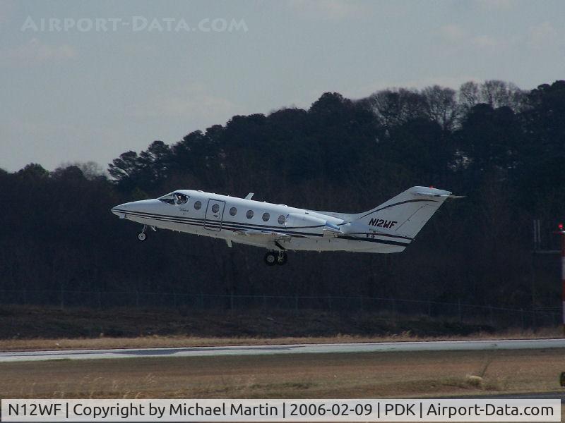 N12WF, 1999 Raytheon BeechJet 400A C/N RK-228, Departing PDK - Starting to rotate gear.