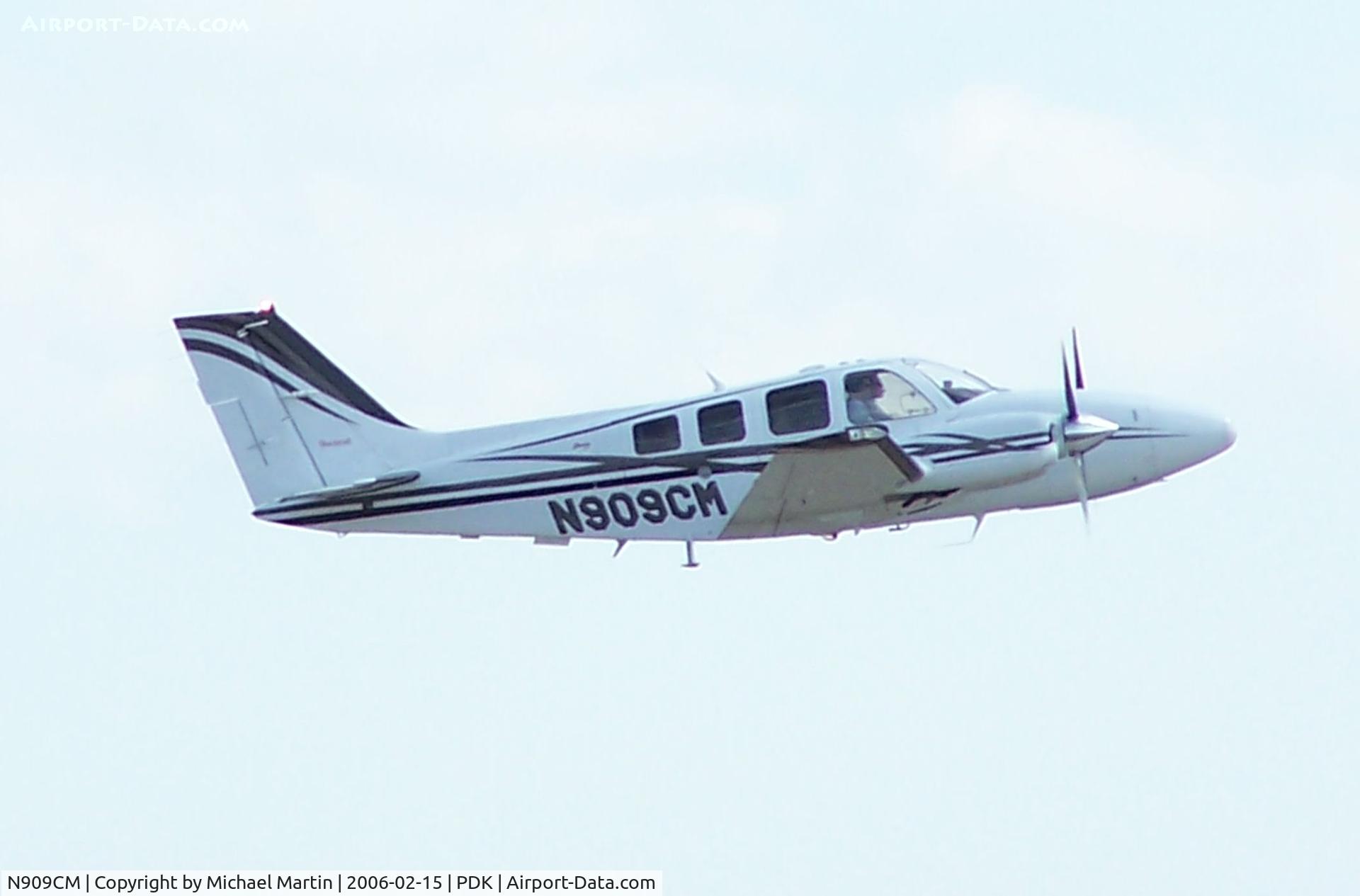 N909CM, 2001 Raytheon Aircraft Company 58 C/N TH-2022, Departing PDK - Gear Up!