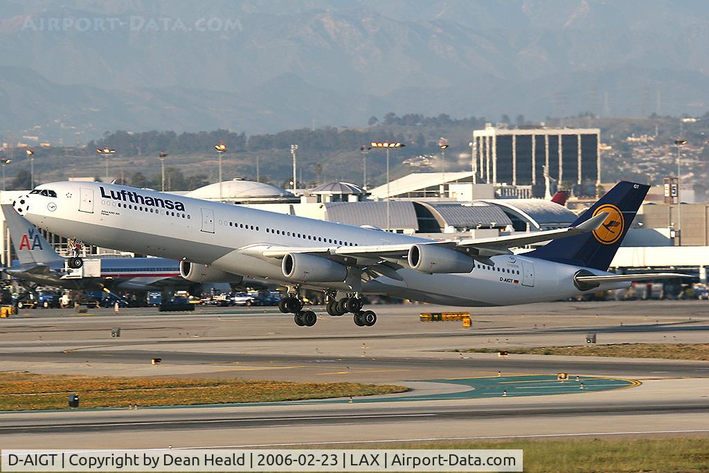 D-AIGT, 1999 Airbus A340-313 C/N 304, Lufthansa D-AIGT (Airbus A340-313) departing LAX RWY 25R on a late afternoon in February 2006.  Note the condensation trailing the winglets.