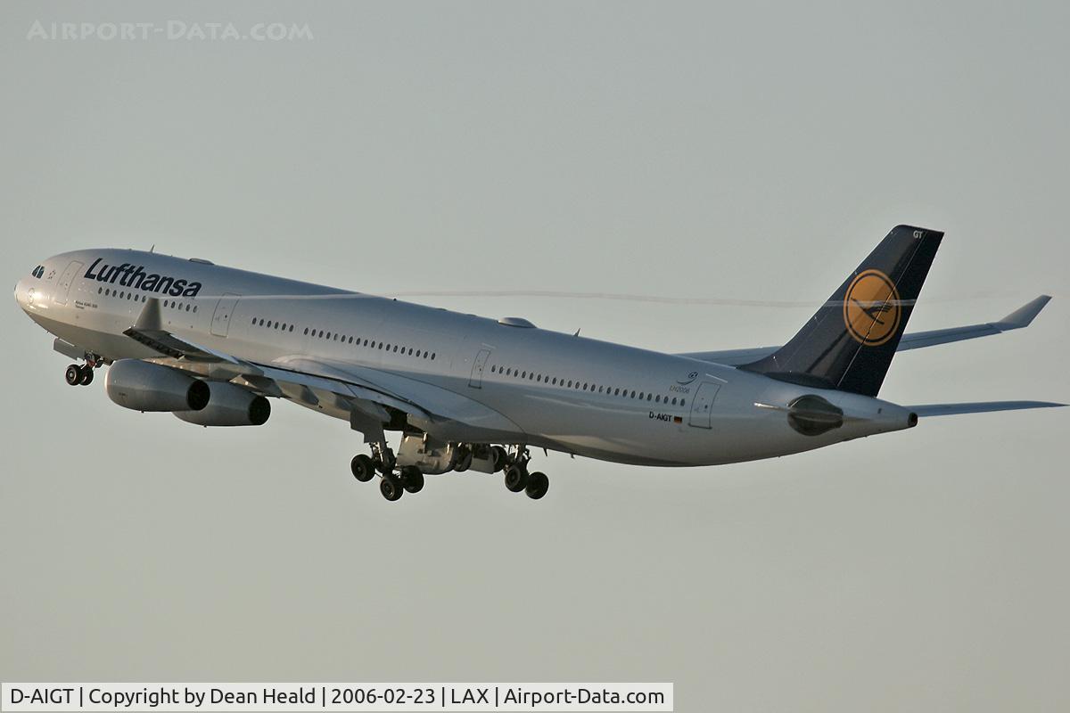 D-AIGT, 1999 Airbus A340-313 C/N 304, Lufthansa B-AIGT (Airbus A340-313) departing LAX RWY 25R on a late afternoon in February 2006. Note the condensation trail originating from the left winglet.
