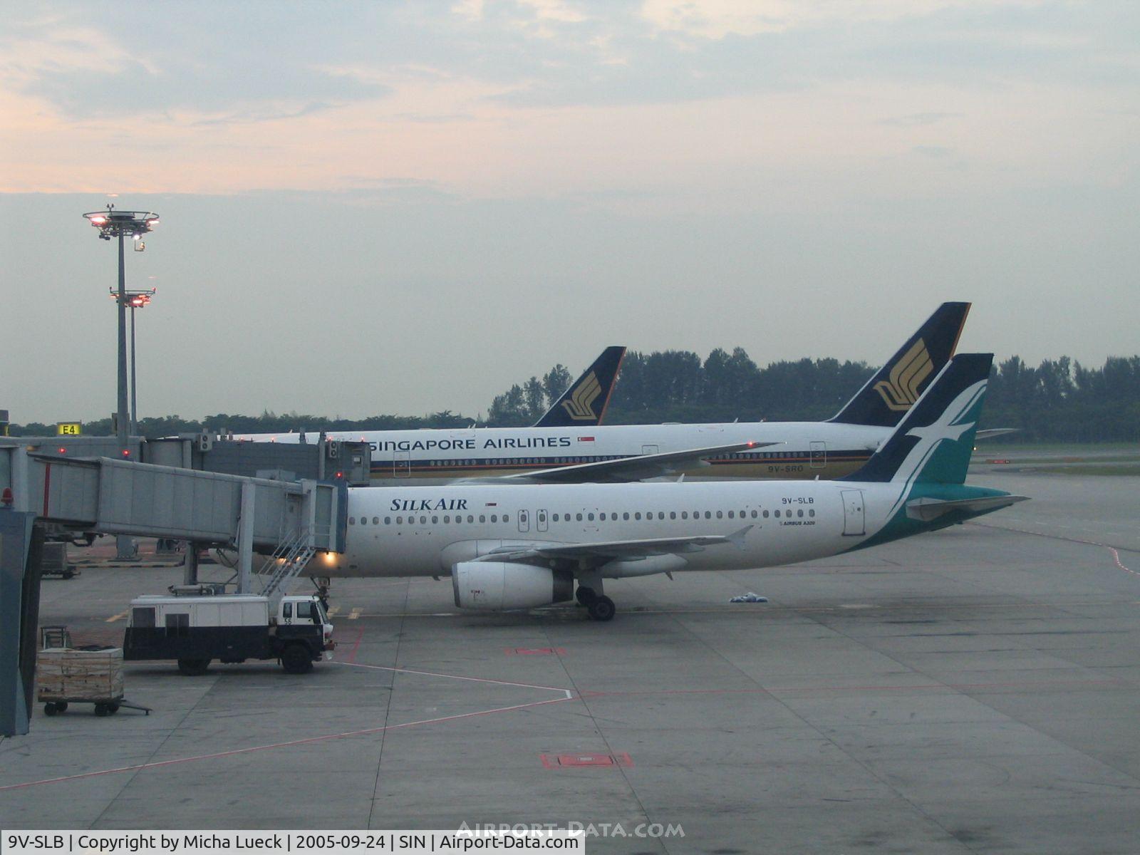 9V-SLB, 1998 Airbus A320-232 C/N 0899, The A320 looks small in front of the B777