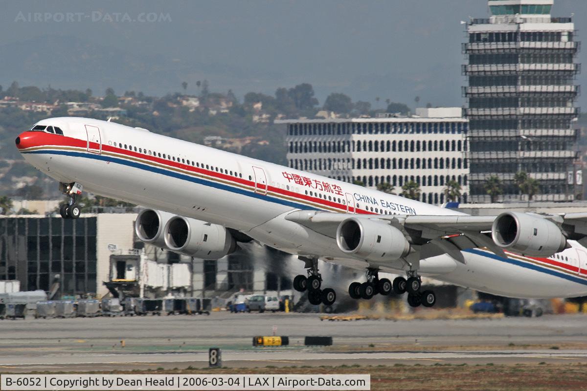 B-6052, 2003 Airbus A340-642 C/N 514, A very poor photograph, but it does capture the moment.  China Eastern B-6052 (FLT 586) departing LAX RWY 25R enroute to Shanghai Pudong (ZSPD).