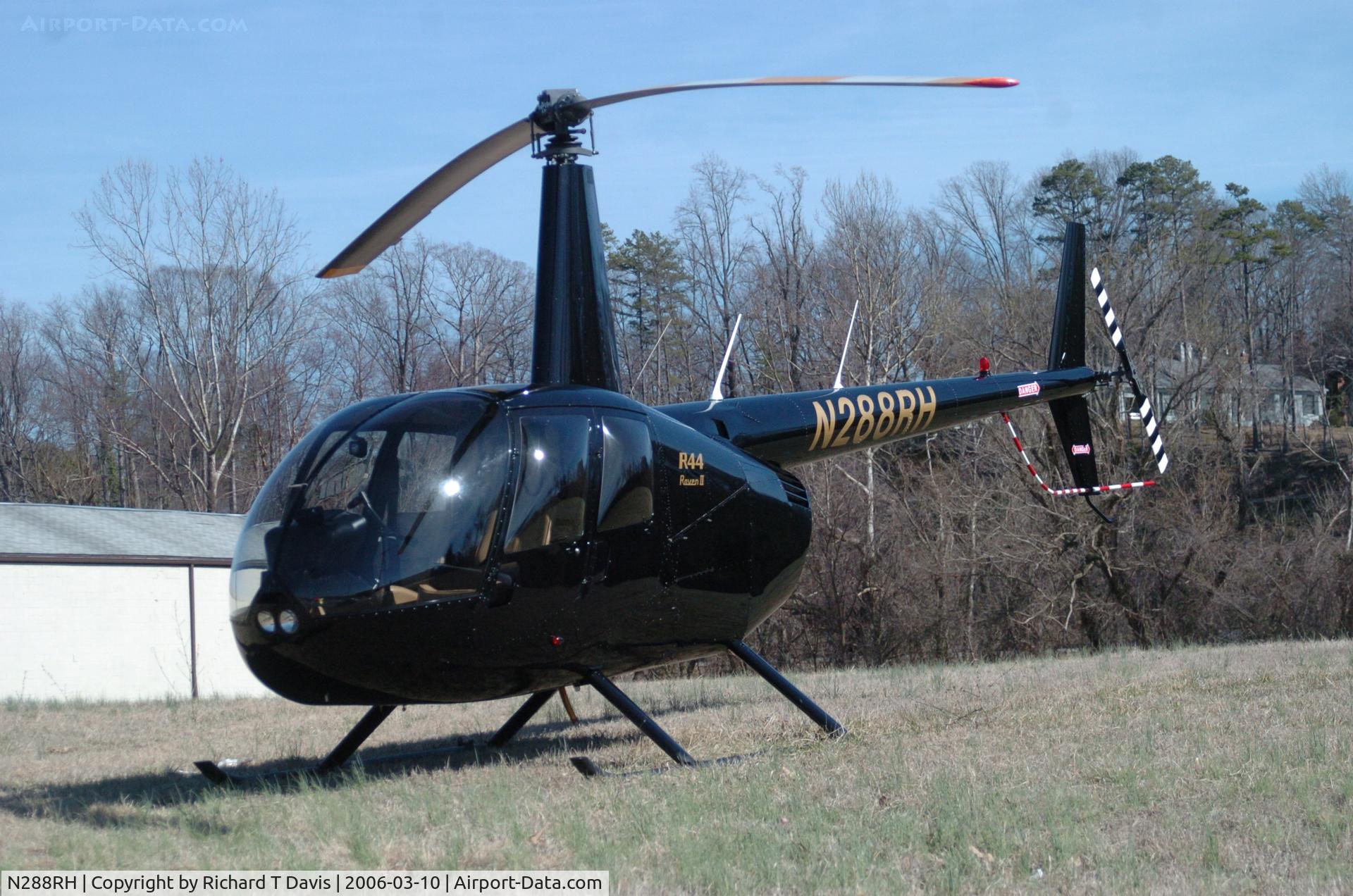 N288RH, 2004 Robinson R44 II C/N 10253, Chopper sitting in a grassy field off Riverside Drive in  Danville Va .3-10-06 with the Dan River about 300 ft. behind it.I saw it several times Friday flying over the city.