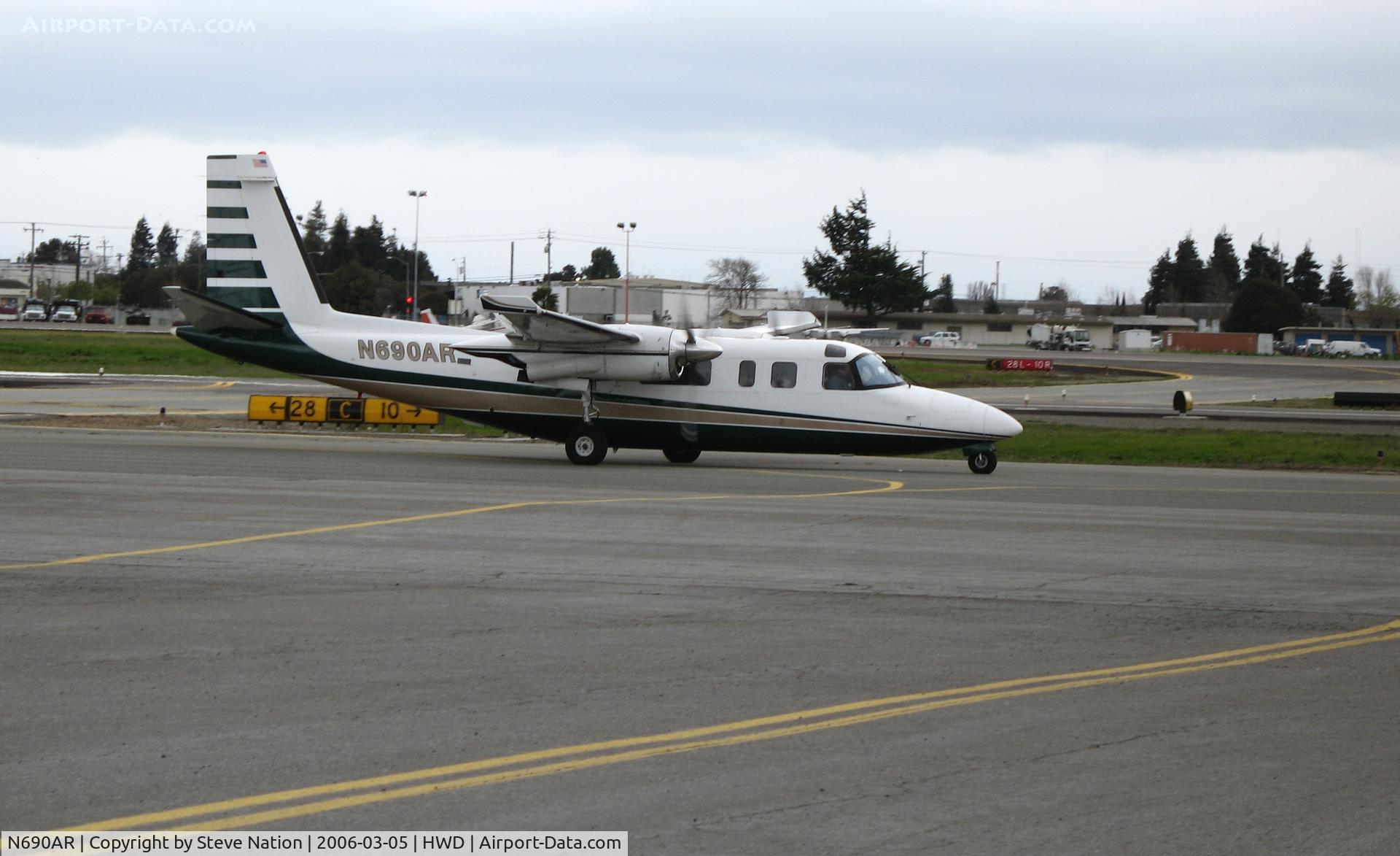 N690AR, 1974 Aero Commander 690A Turbo Commander C/N 11155, Aero Commander 690A taxying in at stormy Hayward Air Terminal, CA