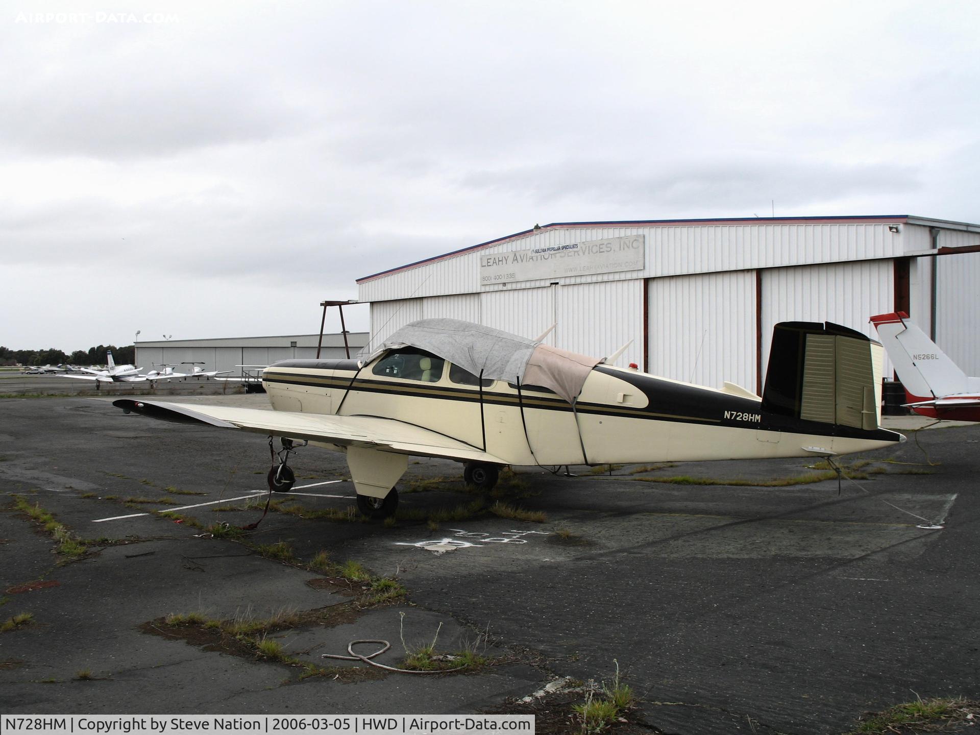N728HM, 1951 Beech C35 Bonanza C/N D-2983, 1955 Beech C35 sans prop & under tarp at stormy Hayward Air Terminal, CA