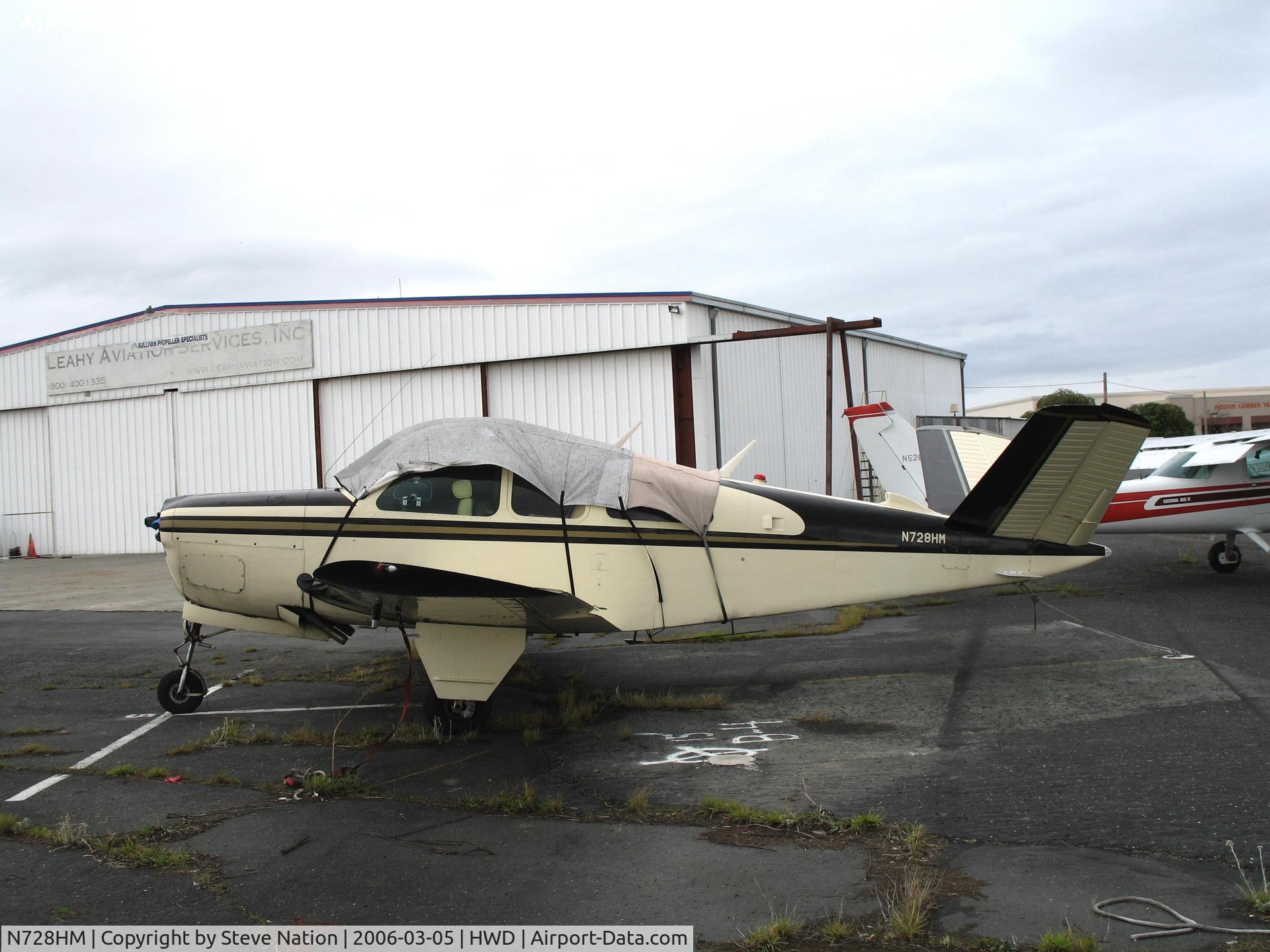N728HM, 1951 Beech C35 Bonanza C/N D-2983, 1955 Beech C35 sans prop & under tarp at stormy Hayward Air Terminal, CA