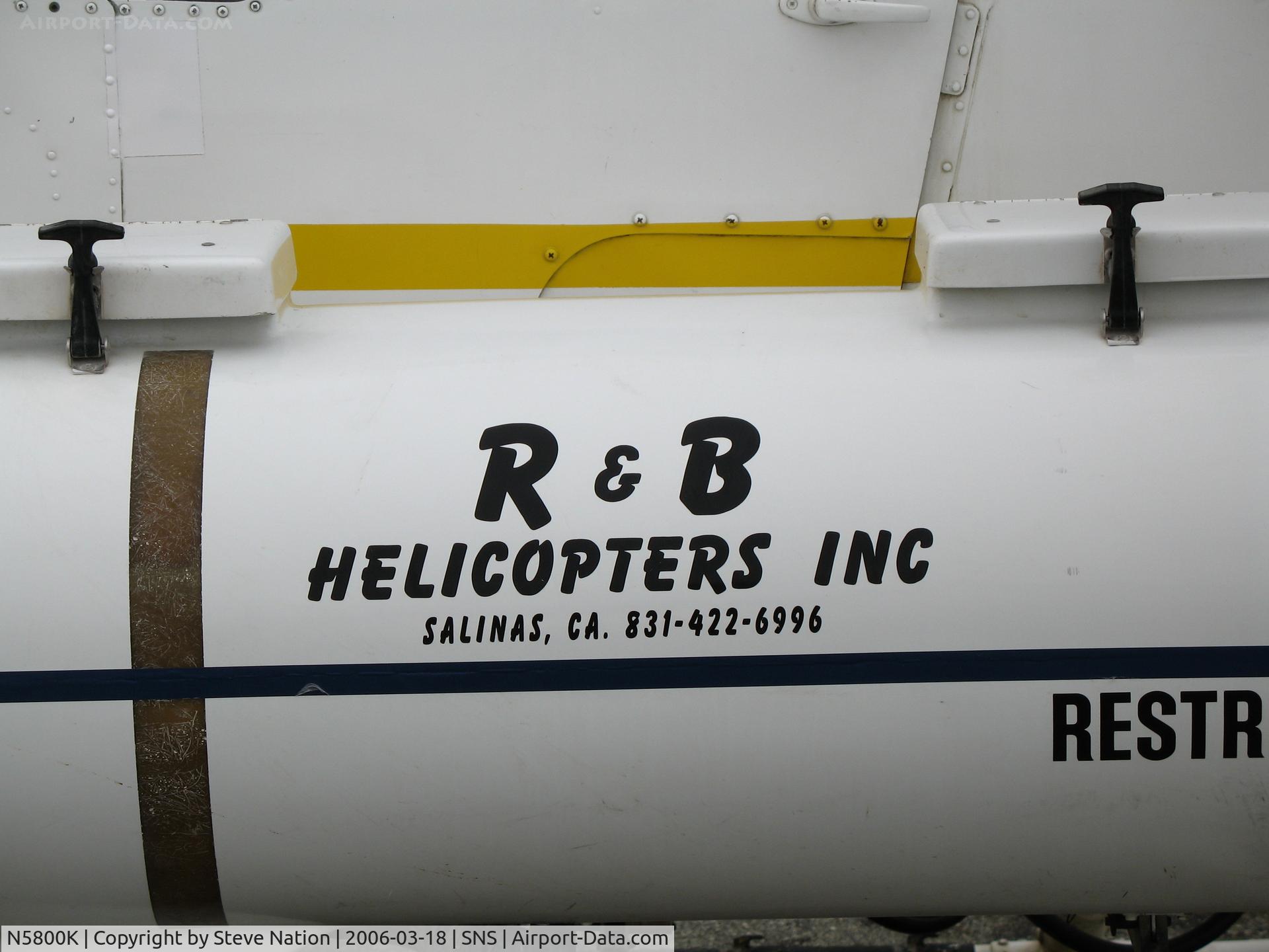 N5800K, 1971 Bell OH-58A C/N 71-20843, Close-up of tank and R & B Helicopters titles on 1971 Bell OH-58A (71-20843) sprayer at Salinas, CA