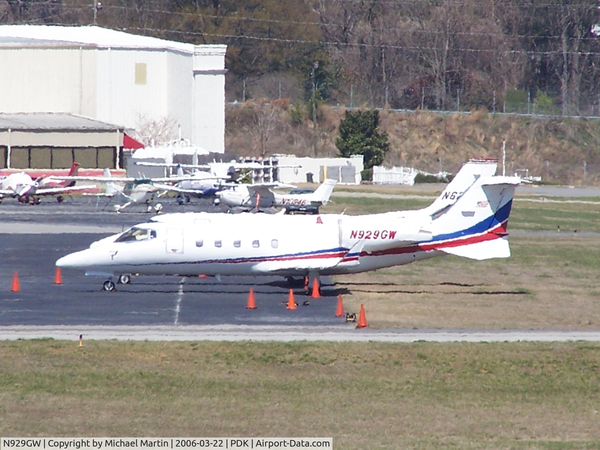 N929GW, 1999 Learjet 60 C/N 165, Tied down @ Signature Flight Services (Long range photo - pardon image)