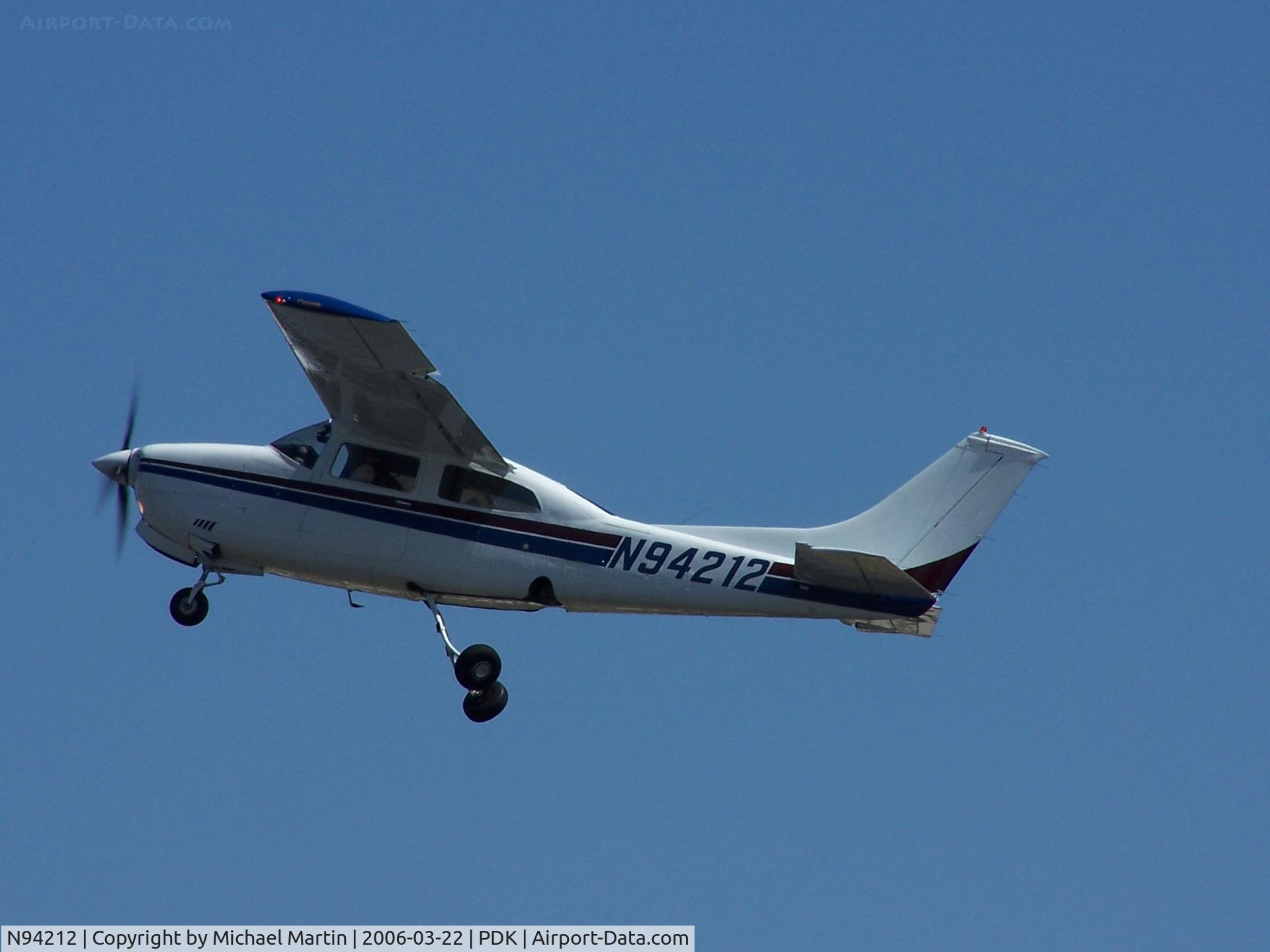 N94212, 1974 Cessna 210L Centurion C/N 21060543, Climbing out of PDK