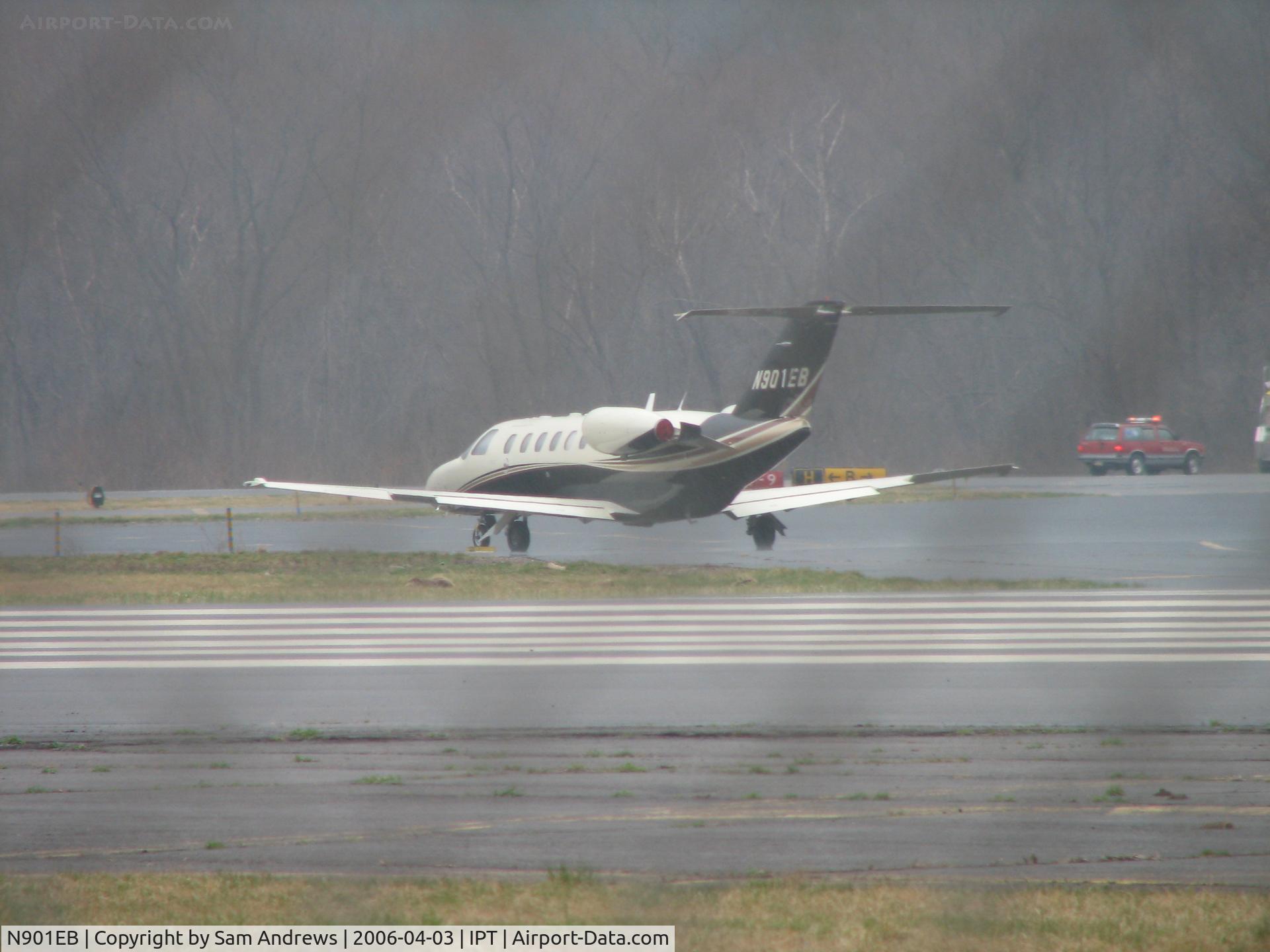 N901EB, 2000 Cessna 525A CitationJet CJ2 C/N 525A0008, Through the fence at IPT on a cloudy 12012KT 10SM OVC026 day.  It was raining at the time I took this picture.  Nice citation.  I don't know what was going on with the emergency vehicles.