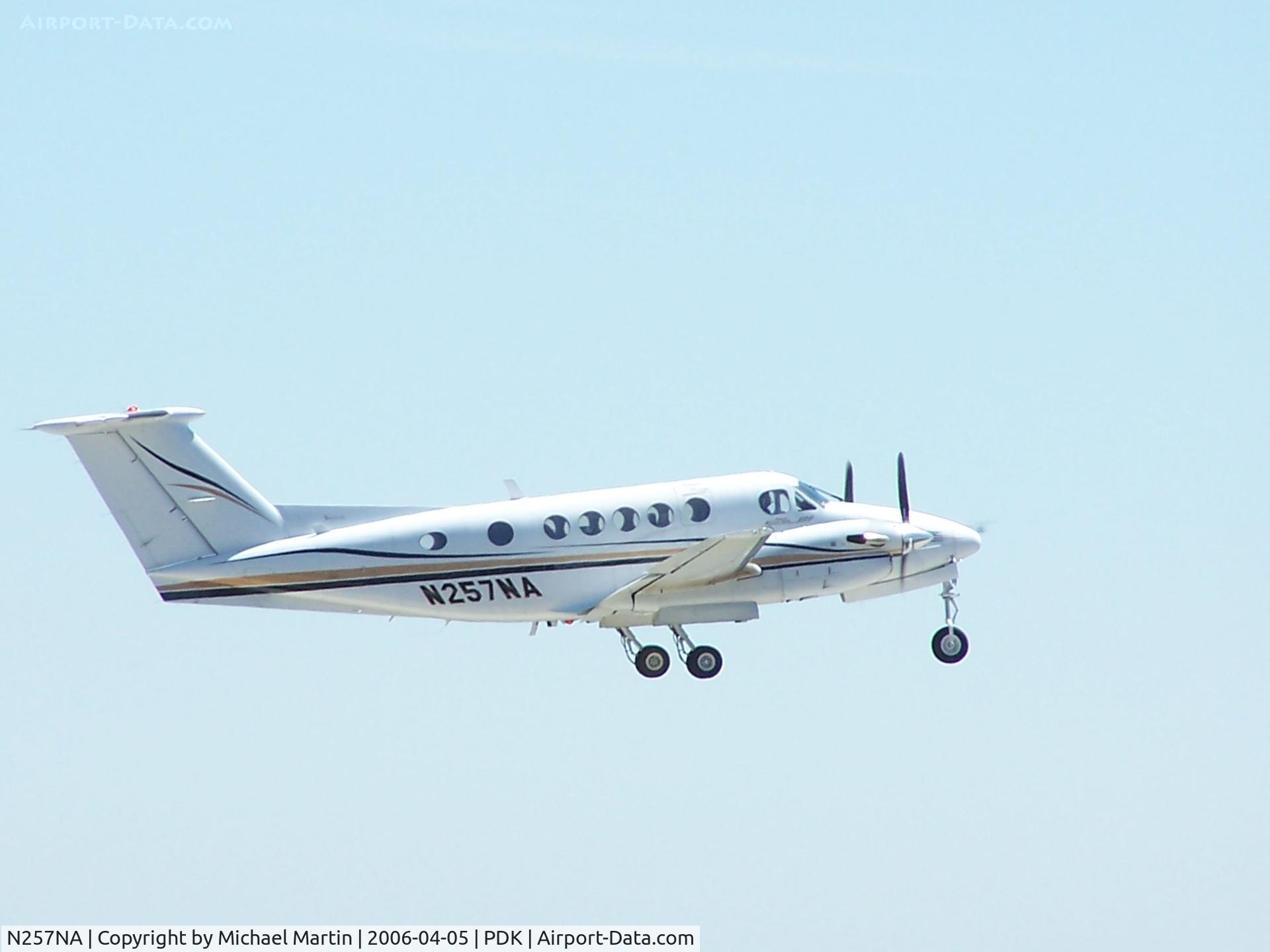 N257NA, 1977 Beech 200 Super King Air C/N BB-257, Departing PDK - Starting to rotate gear.