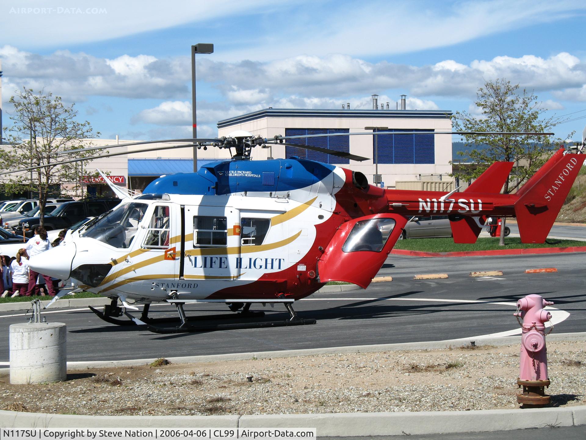 N117SU, Cirrus SR22T C/N 0167, Stanford University LIFE FLIGHT MBB BK 117C-1 in late afternoon sun @ Watsonville (CA) Community Hospital Heliport