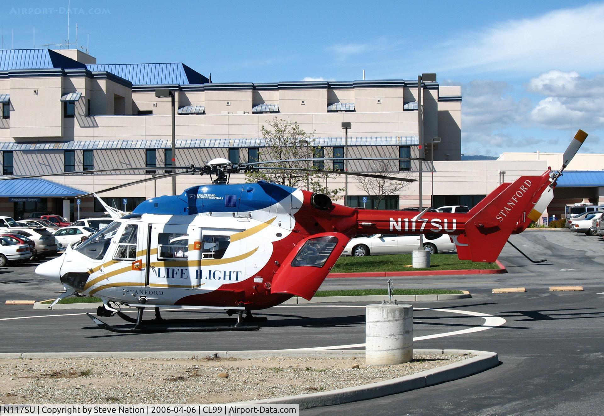 N117SU, Cirrus SR22T C/N 0167, Stanford University LIFE FLIGHT MBB BK 117C-1 in late afternoon sun @ Watsonville (CA) Community Hospital Heliport