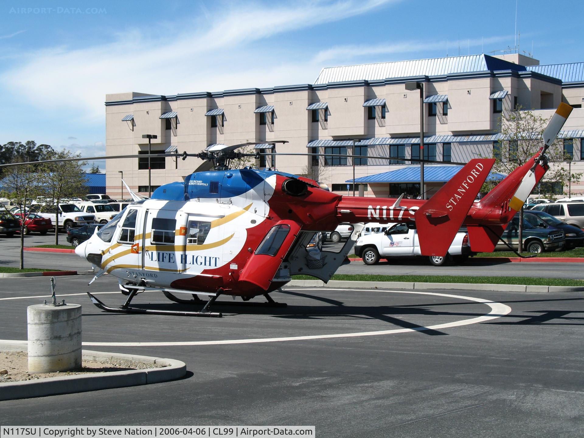 N117SU, Cirrus SR22T C/N 0167, Stanford University LIFE FLIGHT MBB BK 117C-1 in late afternoon sun @ Watsonville (CA) Community Hospital Heliport