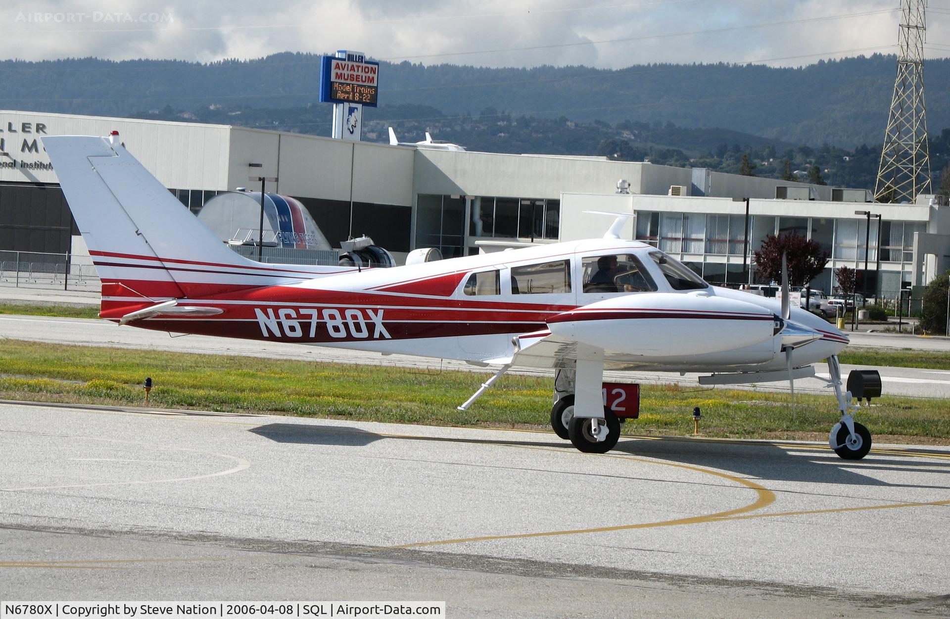 N6780X, 1961 Cessna 310F C/N 310-0080, 1961 Cessna 310F turning onto active runway @ San Carlos Airport, CA in rare spring 2006 sunshine