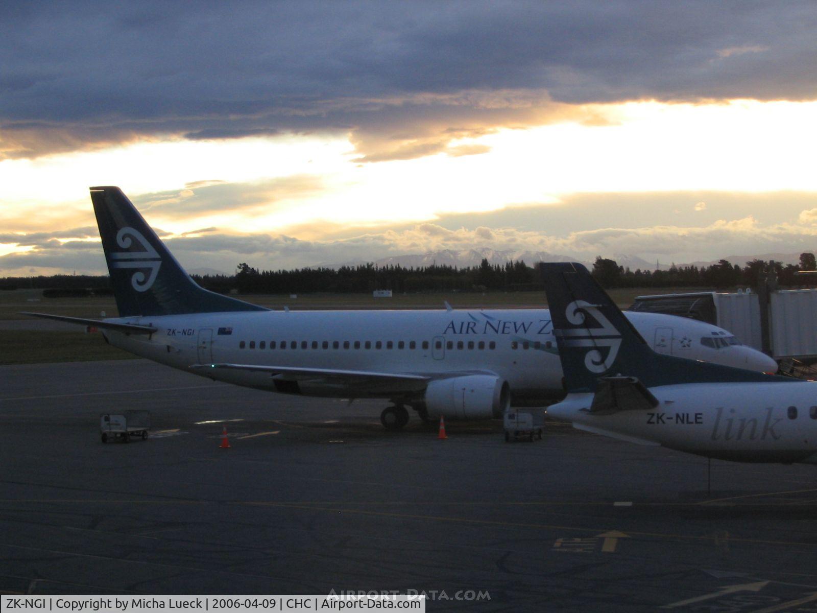 ZK-NGI, 1999 Boeing 737-319 C/N 25608, The sun is setting over the snow-topped mountains