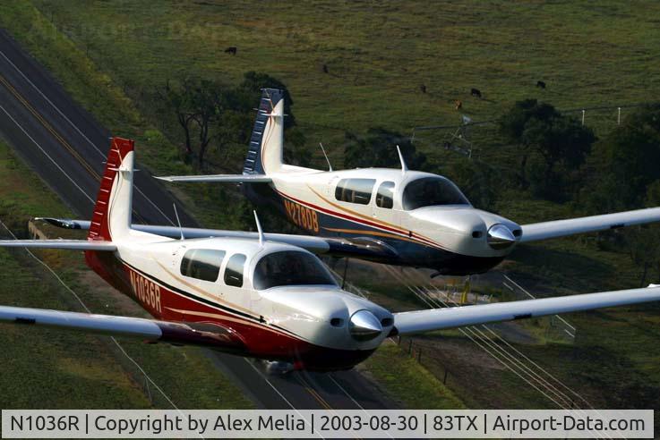 N1036R, 2003 Mooney M20R Ovation C/N 29-0302, N1036R is in the foreground with another Ovation 2 shortly after manufacture in Kerrville