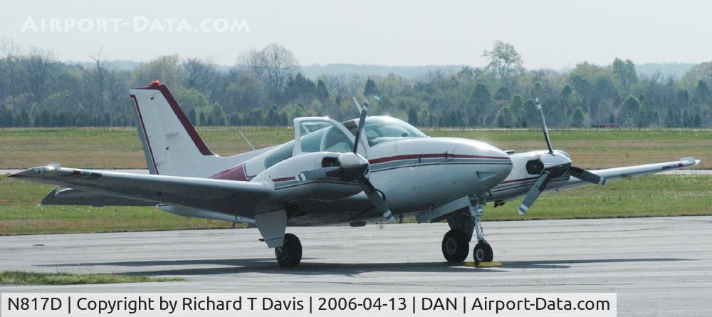 N817D, 1975 Beech E-55 Baron C/N TE-1043, 1975 Beech E-55 just landed with guys carrying hard hats.