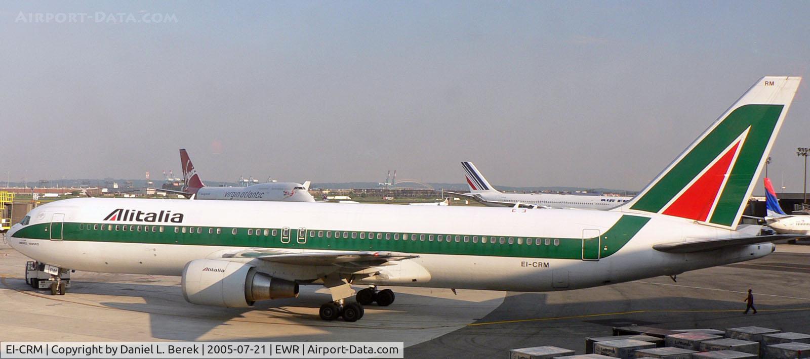 EI-CRM, 1999 Boeing 767-343/ER C/N 30009, Alitalia 767-343 'Amerigo Vespucci' takes advantage of a tow truck to negotiate the tight apron at Newark.