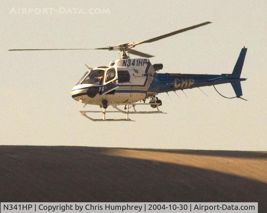 N341HP, 2001 Eurocopter AS-350B-3 Ecureuil Ecureuil C/N 3407, A CHP helicopter hovers over a possible suspect in Oakland California