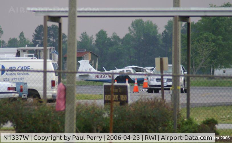 N1337W, 1963 Mooney M20E C/N 225, Seen from far across the field.  Makes her look all the more lonely
