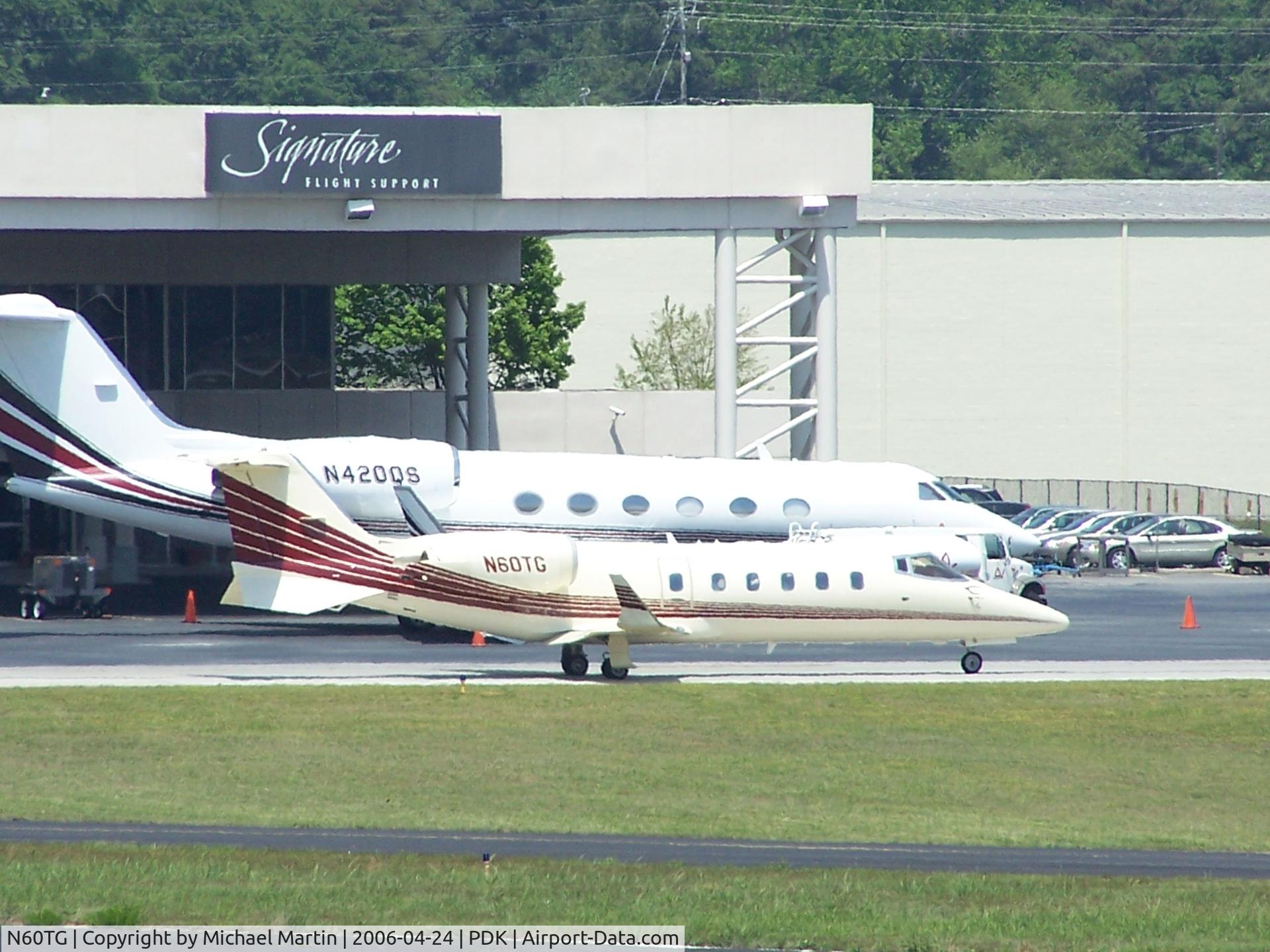 N60TG, 2001 Learjet 60 C/N 225, Taxing past Signature Air Service.