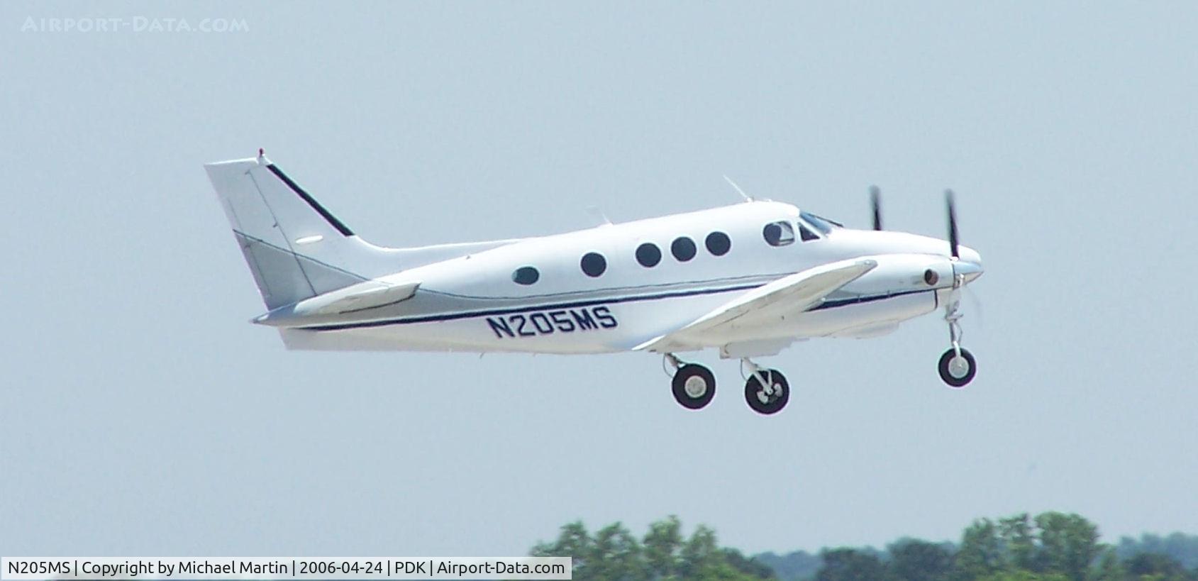 N205MS, 1981 Beech C90 King Air C/N LJ-948, Departing PDK - Starting to rotate gear.