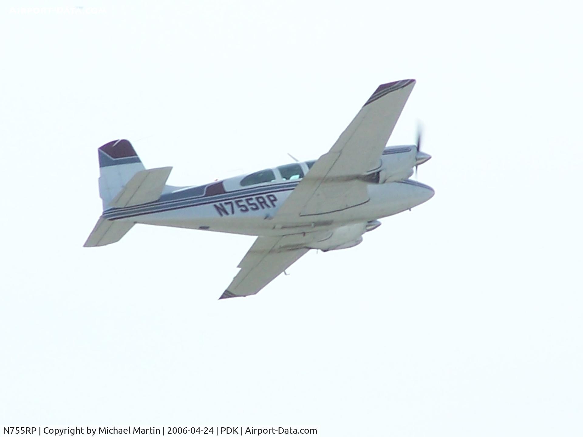 N755RP, 1961 Beech B95A Travel Air C/N TD-487, Departing PDK against a bright sun