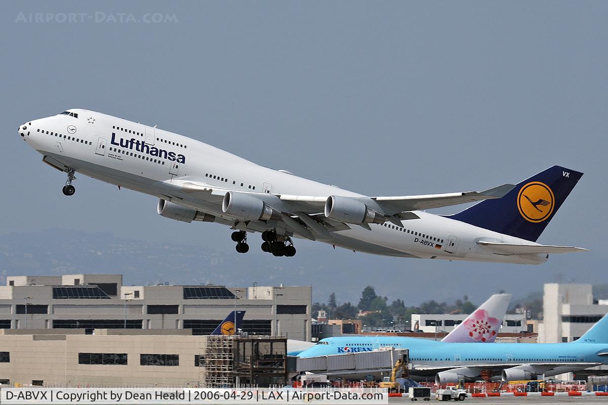 D-ABVX, 1999 Boeing 747-430 C/N 29868, Lufthansa D-ABVX (FLT DLH457) departing RWY 25R enroute to Frankfurt Main (EDDF), Germany.  Gated at the terminal in the background are Korean Air HL7473, China Airlines B-18210, and Lufthansa D-AIGM.