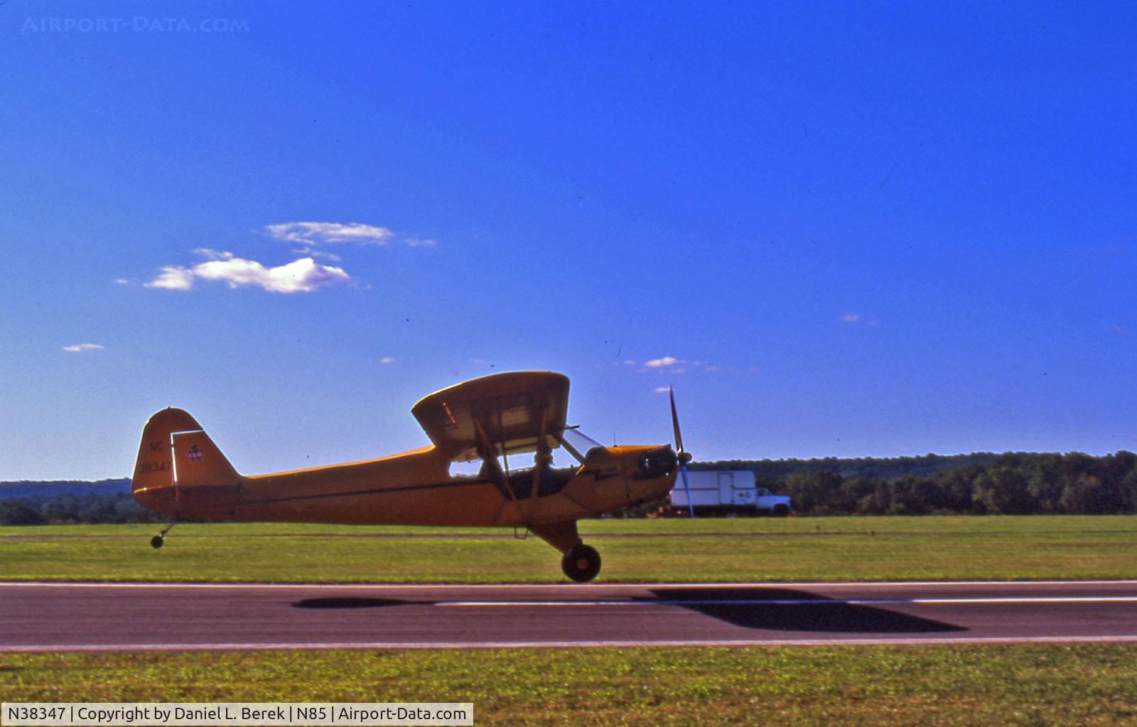 N38347, 1941 Piper J3C-65 Cub C/N 6955, Gorgeous yellow Piper Cub NC38347 takes to the air at the Sussex County (New Jersey) airshow.