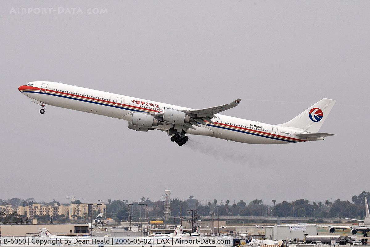 B-6050, 2002 Airbus A340-642 C/N 468, China Eastern B-6050 departing RWY 25R trailing brake dust.