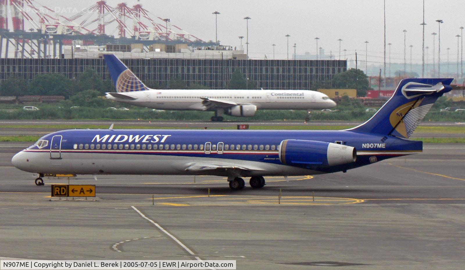 N907ME, 2003 Boeing 717-200 C/N 55171, A Midwest Boeing 717-200 (MD-95) prepares to leave for Milwaukee as a Continental 757 touches down.