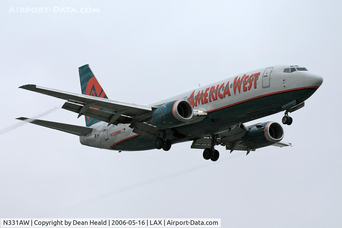 N331AW, 1987 Boeing 737-3Y0/SF C/N 23747, America West N331AW (FLT AWE32) from Phoenix Sky Harbor Int'l (KPHX), with visible condensation trails from the outboard edges of the flaps, on final approach to RWY 24R.