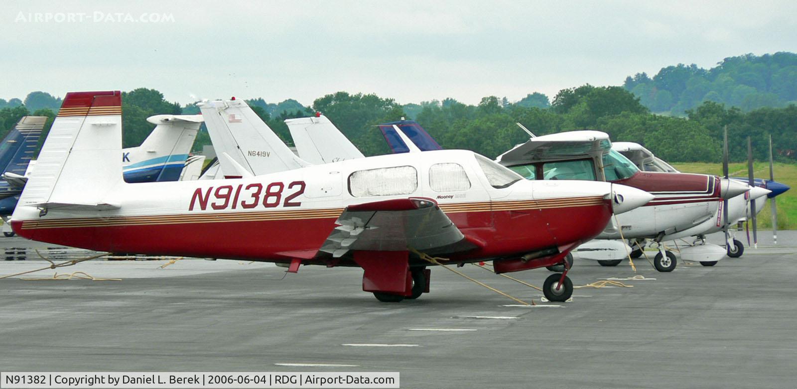 N91382, 1991 Mooney M20J 201 C/N 24-3238, A Mooney M20J heads a line-up on Reading's general aviation ramp.