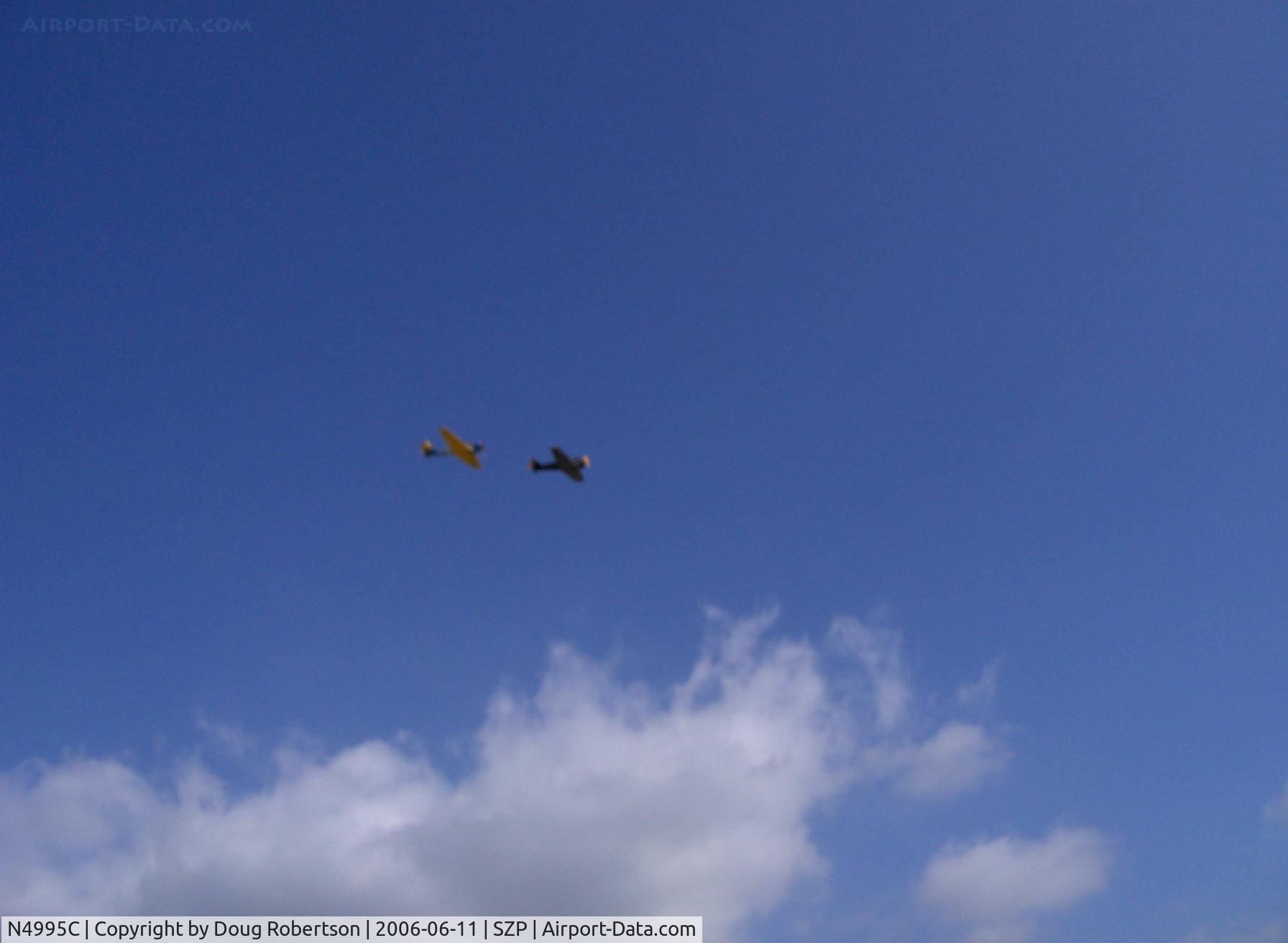 N4995C, 1949 North American T-6G Texan C/N 168-481, Yellow-winged North American T-6G TEXAN (1949 factory reman) 'Thirsty Girl' in echelon flight with another TEXAN