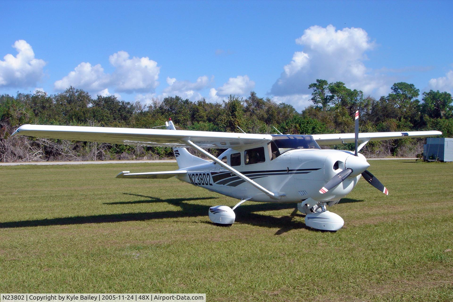 N23802, 2000 Cessna 206H Stationair C/N 20608137, Parked in the grass at Manatee Airport (48X)