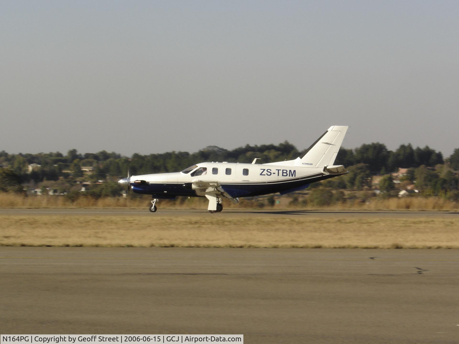N164PG, Socata TBM-700 C/N 164, This aircraft is now registered ZS-TBM and is seen here landing at Grand Central Airport in Johannesburg South Africa.