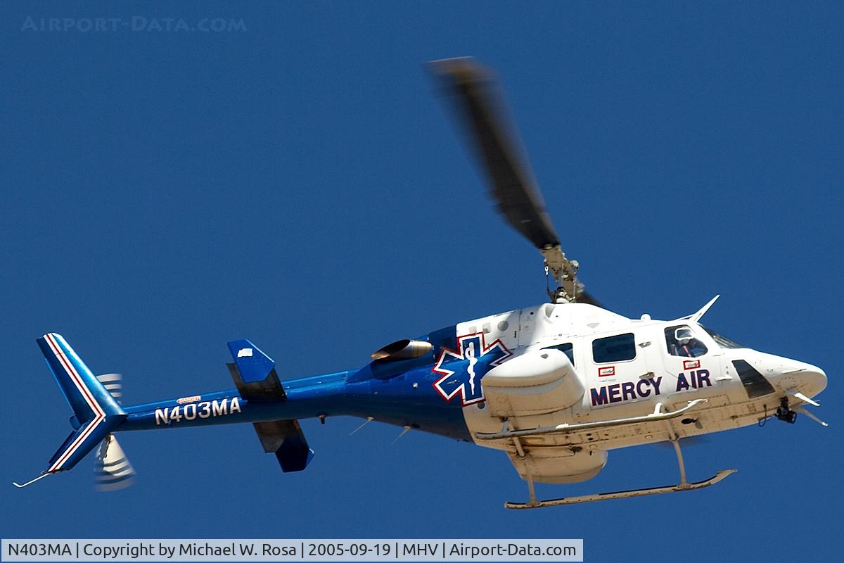 N403MA, Bell 222U C/N 47516, Flying over the McDonalds next to the airfield.