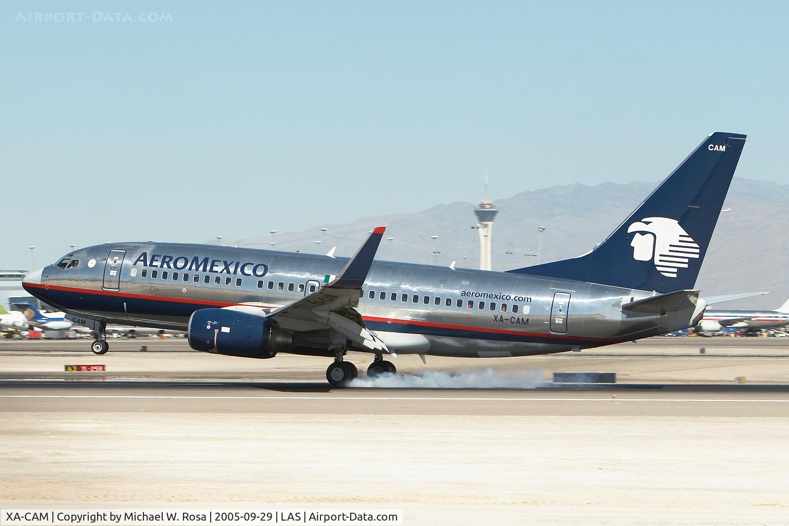 XA-CAM, 2003 Boeing 737-752 C/N 33785, Smokey touchdown on runway 25L with the Stratosphere Tower in the background. A little motion blur to give it that extra touch.
