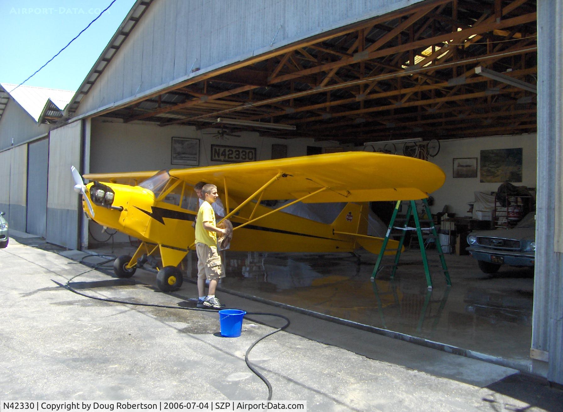 N42330, 1941 Piper J3C-65 Cub Cub C/N 14580, 1941 Piper J3C-65 CUB, Continental A&C65 65 Hp, washing the Cub for the 22nd annual West Coast Piper Cub Fly-In, Lompoc, CA Airport