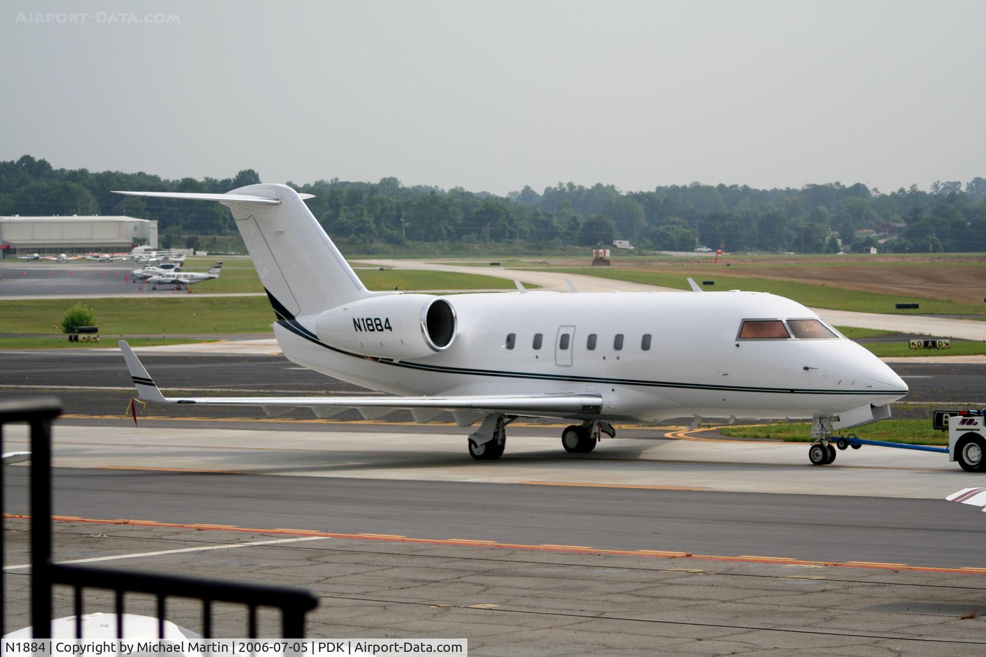 N1884, 1981 Canadair Challenger 600 (CL-600-1A11) C/N 1032, Being towed to parking at Mercury Air Center