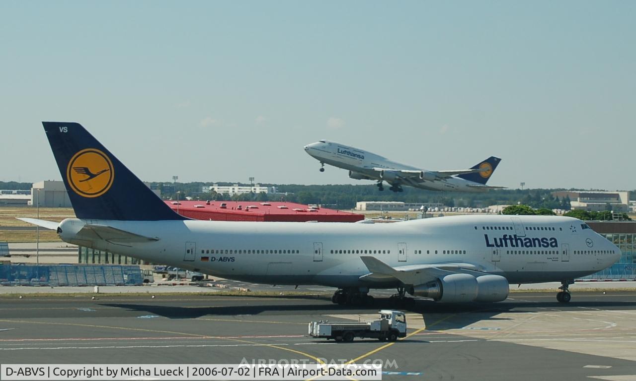 D-ABVS, 1997 Boeing 747-430 C/N 28286, D-ABVS taxiing for the runway, and D-ABTC taking off in the background (with Soccer Worldcup nose)