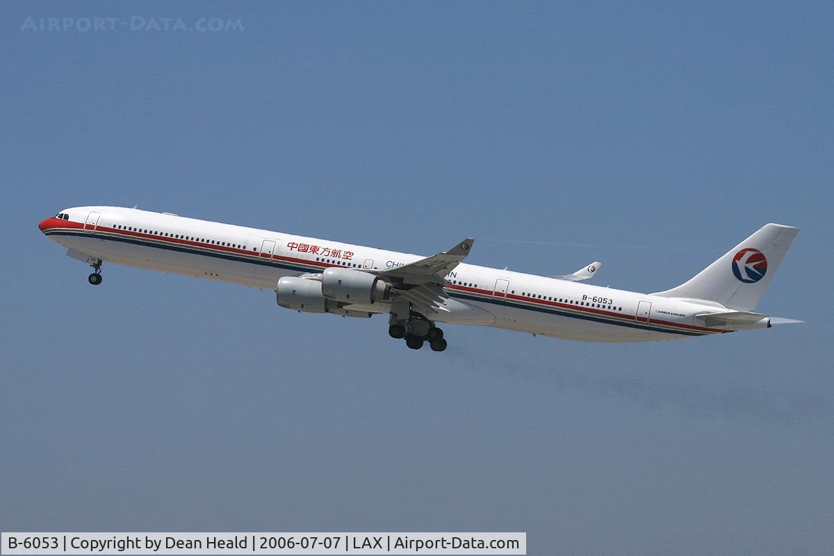 B-6053, 2004 Airbus A340-642 C/N 577, China Eastern A-340-642 B-6053 (FLT CES586) climbing out from RWY 25R, trailing brake dust, enroute to Shanghai Pudong (ZSPD), China.
