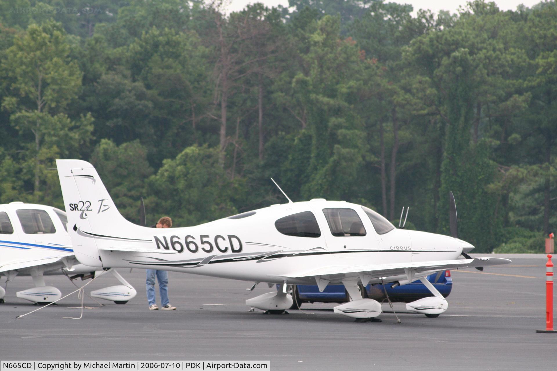 N665CD, 2006 Cirrus SR22 GTS C/N 1774, Tied down @ PDK with vairous AC in background