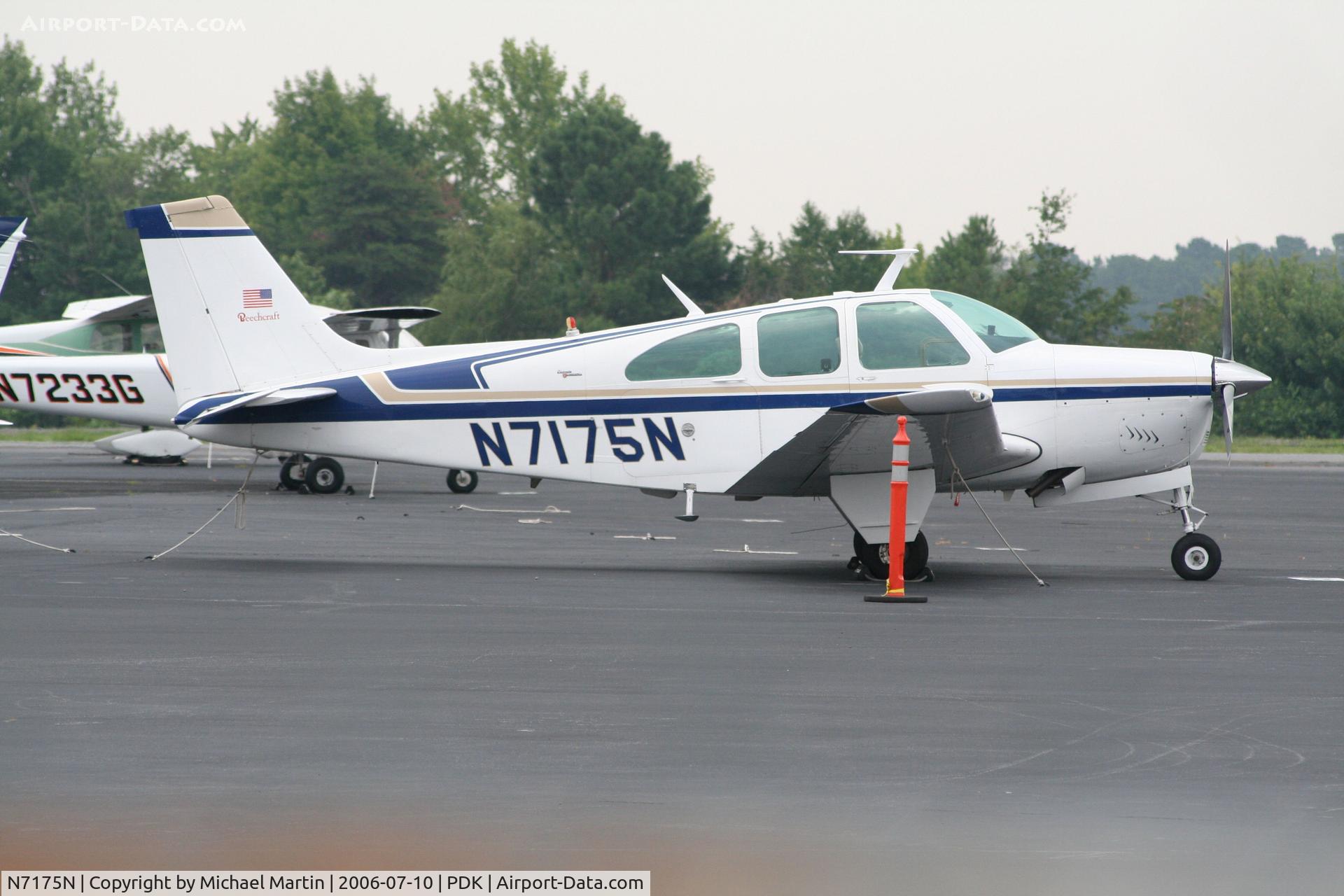 N7175N, 1968 Beech E33A Bonanza C/N CE-201, Tied down @ PDK with vairous AC in background